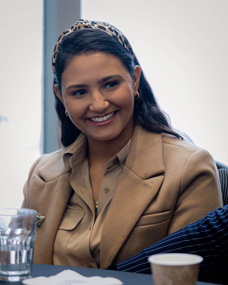 Woman smiling during ICC's roundtable discussions.