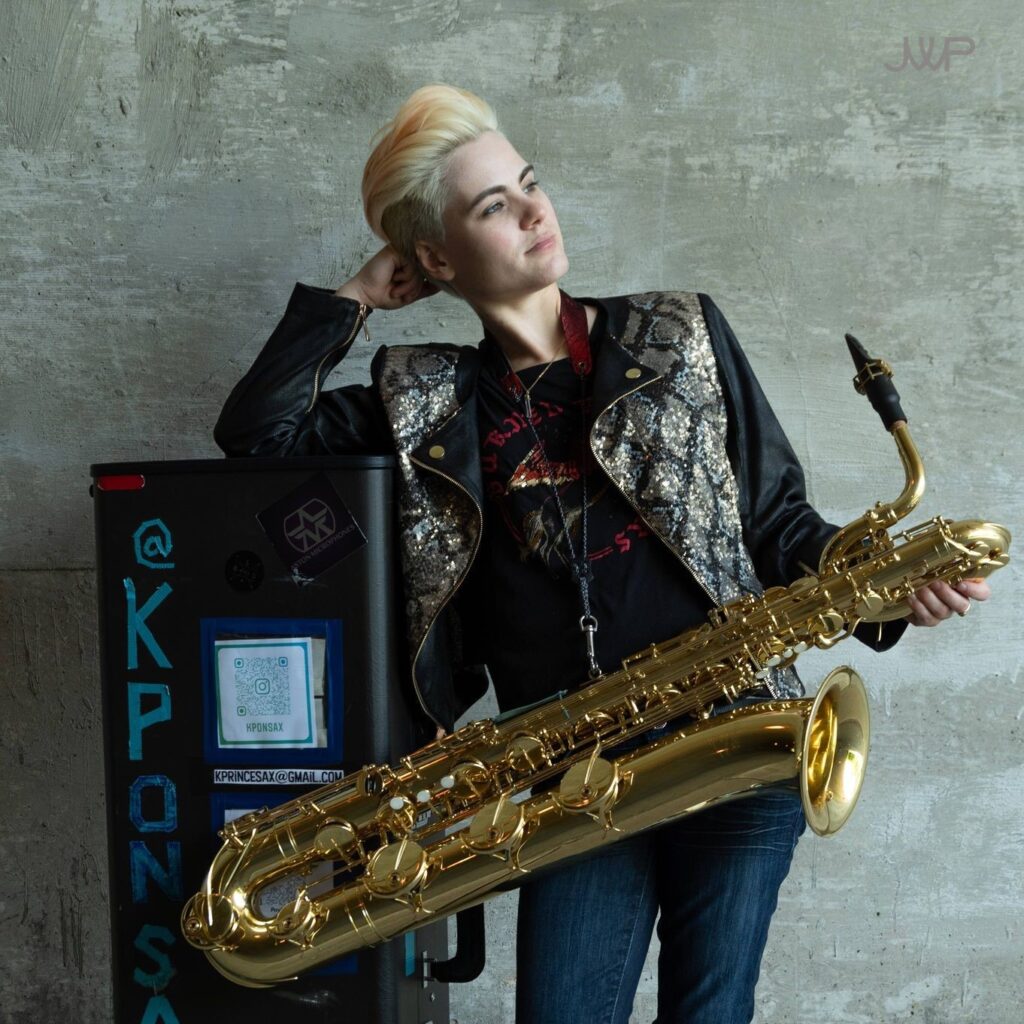 Photograph of musician, Kristen Prince holding a saxophone.
