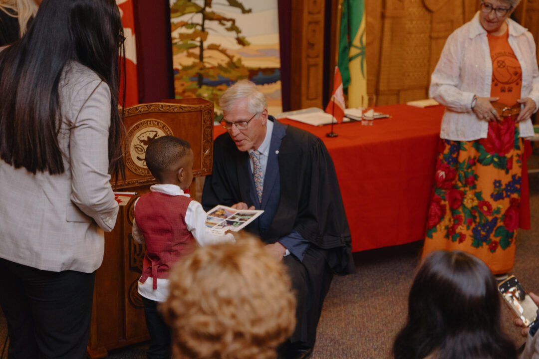 Child receiving their citizenship documents.