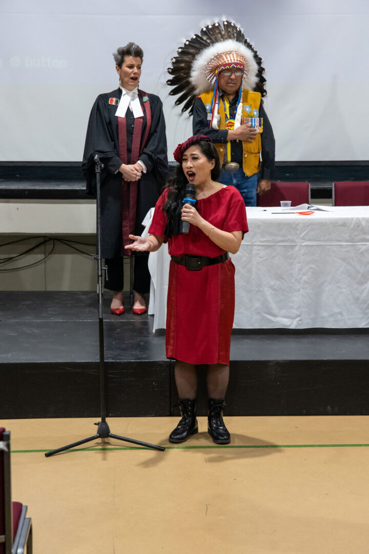 Crislyne singing the Canadian national anthem at a citizenship ceremony.