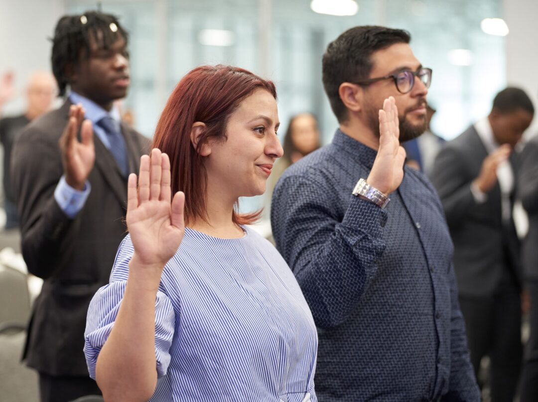 People taking the oath of citizenship at a Canadian citizenship ceremony.