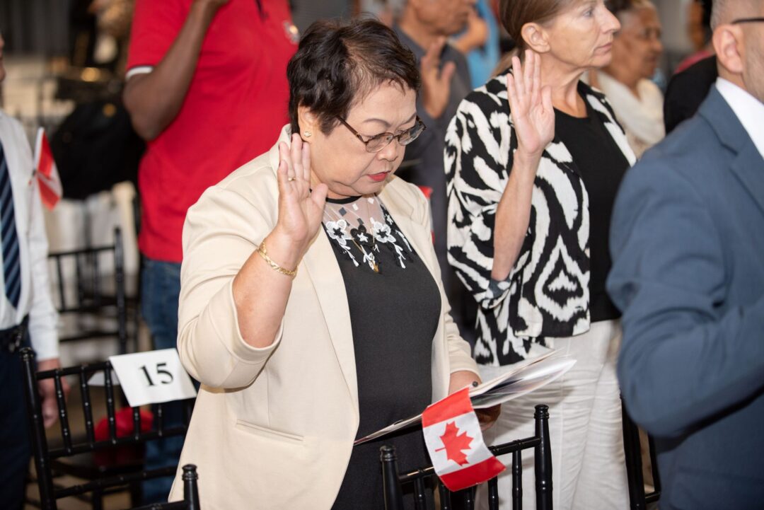New Canadian citizen taking the oath of citizenship.